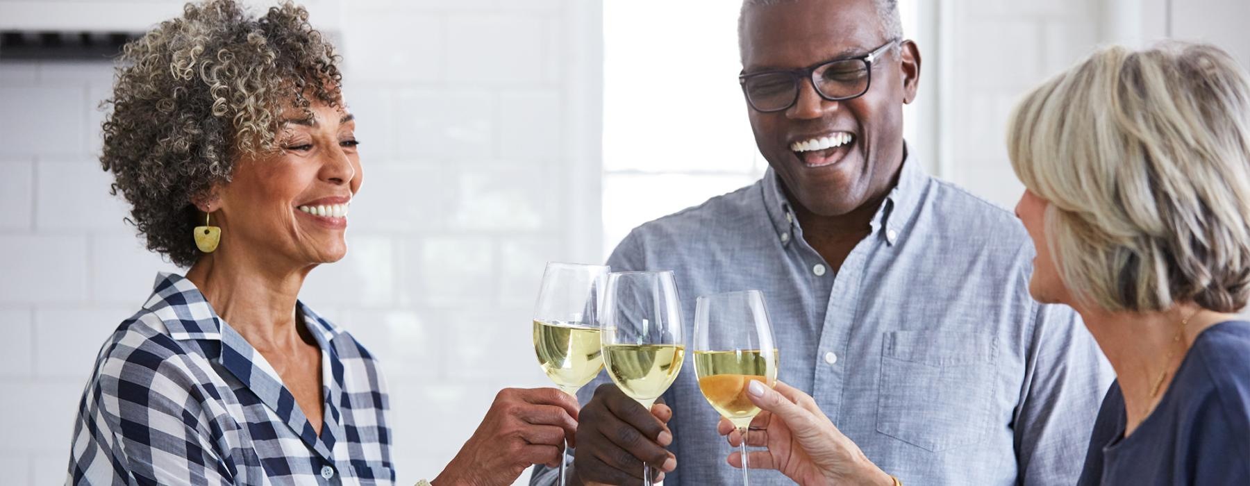 a few people toasting wine glasses