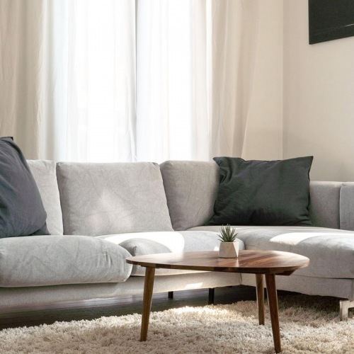 Wide open living areas flooded with natural light oversized windows brighten spacious, furnished living room